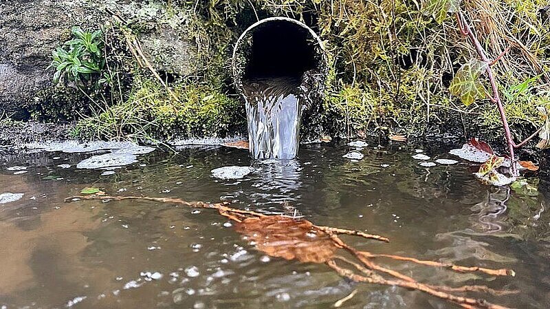 Sewerage pipe emptying into river