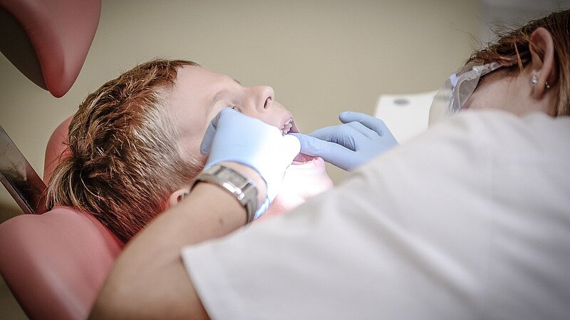 Blond boy having a dental checkup